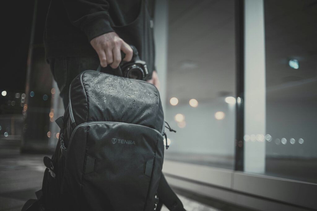 Traveler holding camera and backpack – prepared for travel insurance protection